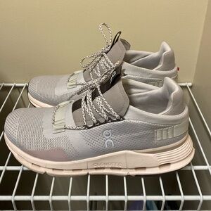 On Cloudnova in light pink, gray, and brown.